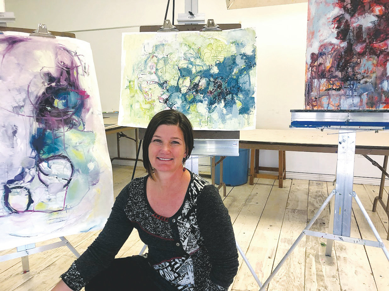 Nikki Nienhuis sits with her artwork in Foothills Art Center’s Open Studio Classroom in 2019.